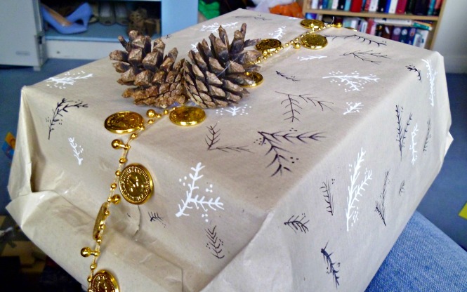Brown paper once again. Grab some pens and decorate it yourself - these hand drawn branches are a doddle. Add some sparkle with ribbon or coins and hot glue some pinecones to finish it all off.